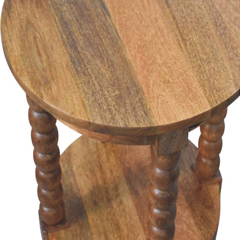 Spindle round side table with turned spindle legs and a golden teak finish lower shelf in warm natural wood