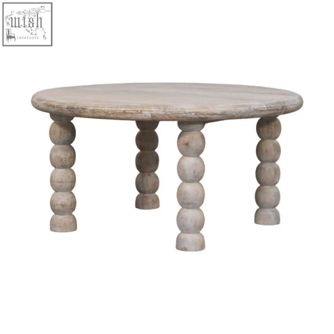 A round light gray oak coffee table with turned bead legs in spindle salted oak solid mango wood style