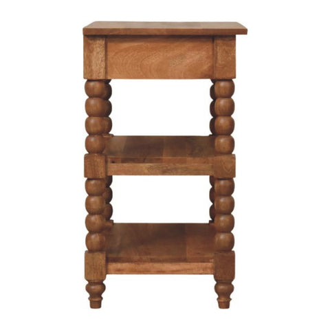 A spindle side table with turned bead legs and two open shelves in a warm golden teak finish wood
