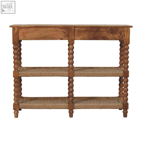 A rustic wooden spindle woven console table with turned legs and woven wicker shelves for stylish storage