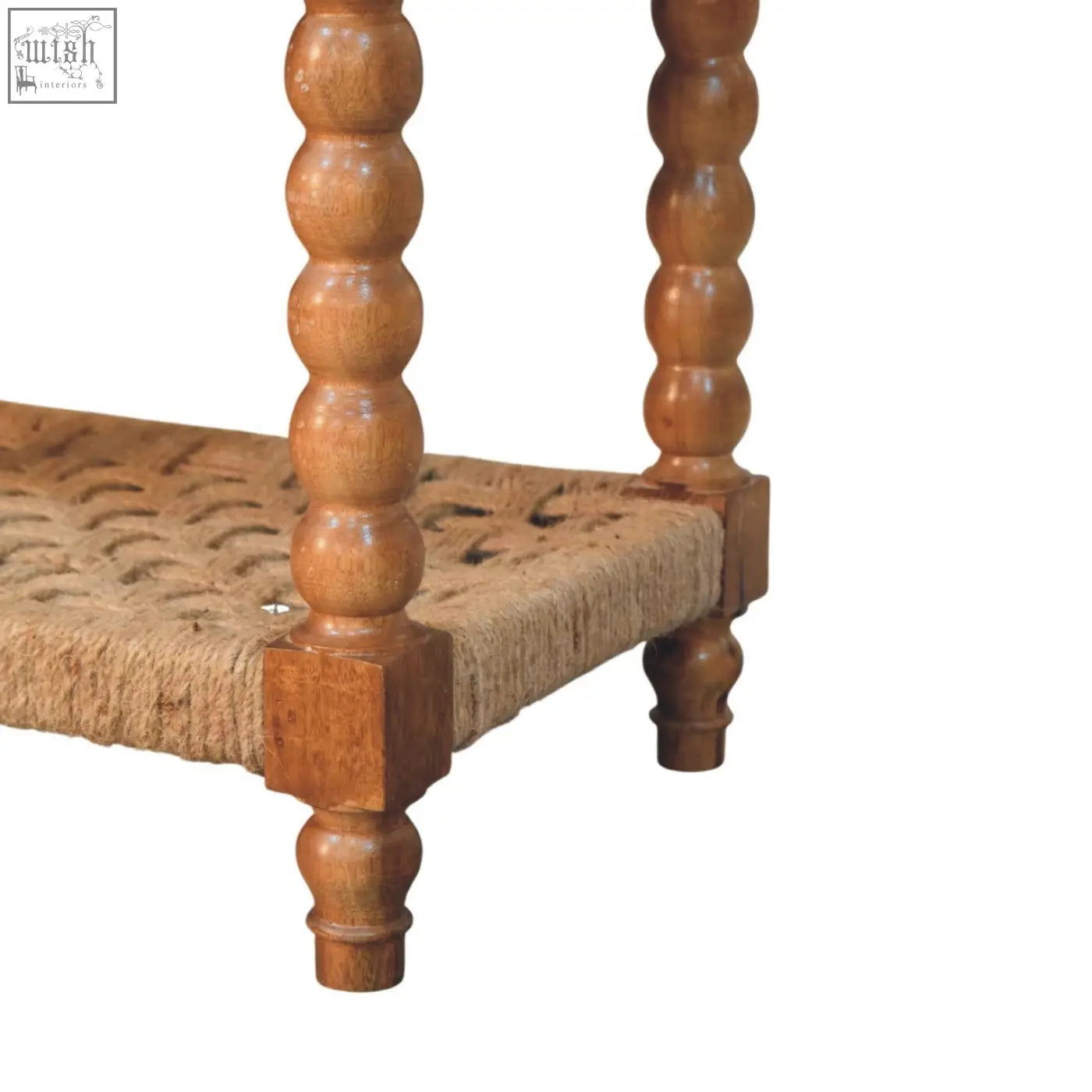 A rustic wooden spindle woven console with turned spindles and a natural jute shelf for stylish storage
