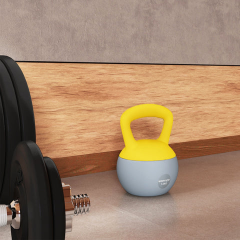 A vibrant yellow and light blue sportnow 12kg soft kettlebell with a non-slip handle filled with metal sand