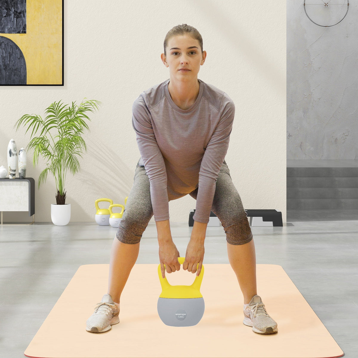 Yellow and gray sportnow 12kg soft kettlebell with non-slip handle and metal sand for home strength training