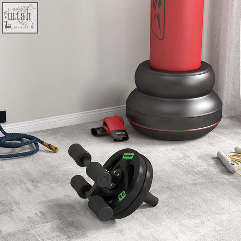 Black ab roller with green accents alongside 10kg weight plate and sportnow 2 x 5kg weight plates set for strength training