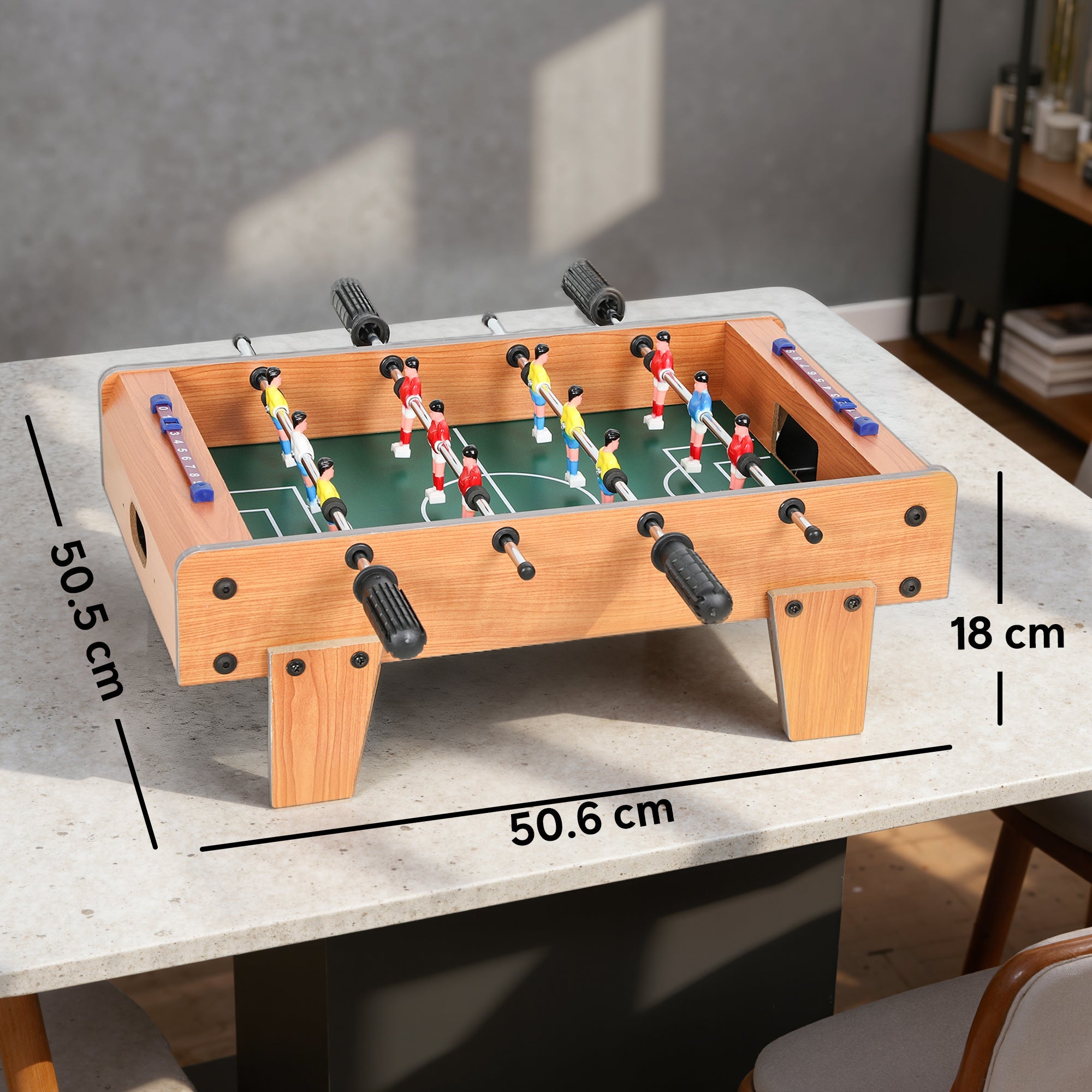 Wooden football table with green field, colorful players, stainless steel rods, black handles, nature wood finish