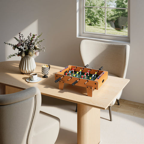 Wooden football table with colorful players and stainless steel rods featuring a nature wood finish for indoor fun