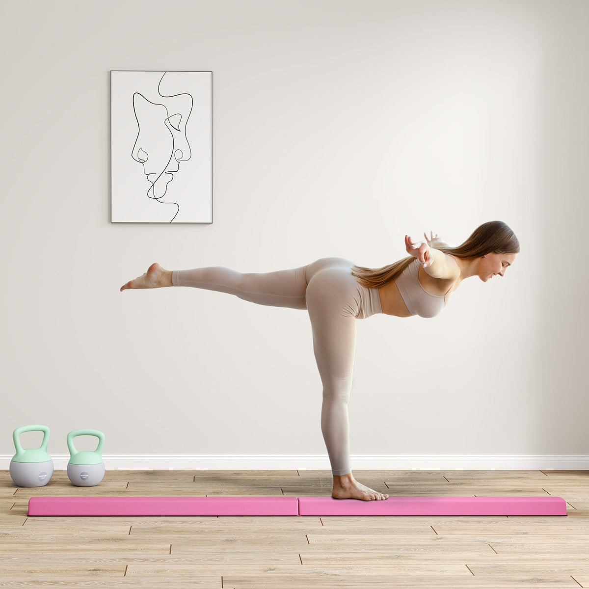 A woman on a vibrant pink foam mat practices yoga next to a pink sportnow folding balance beam with eva foam core