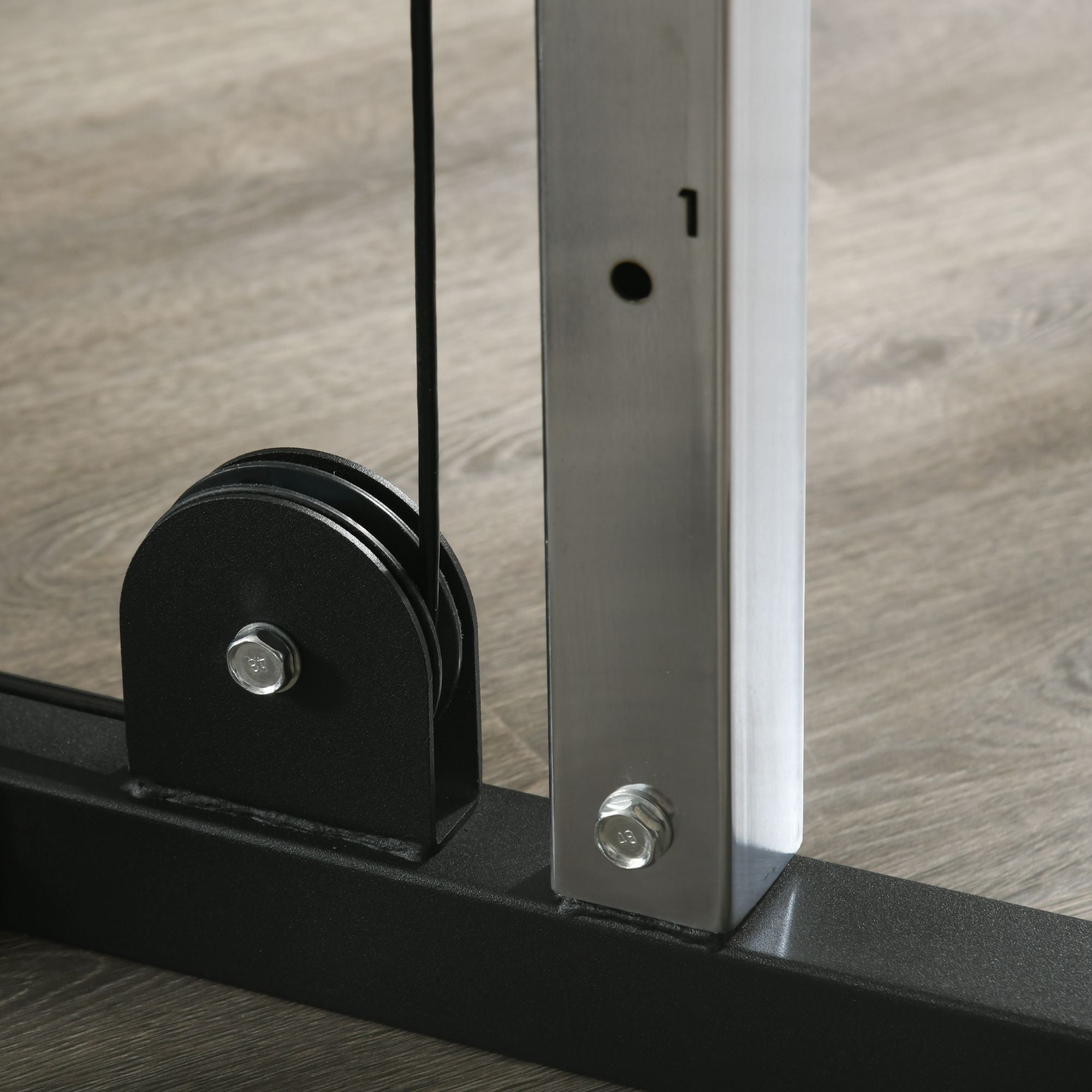 Black pulley with silver bolt on sportnow home gym machine metal frame for strength training low pulleys setup