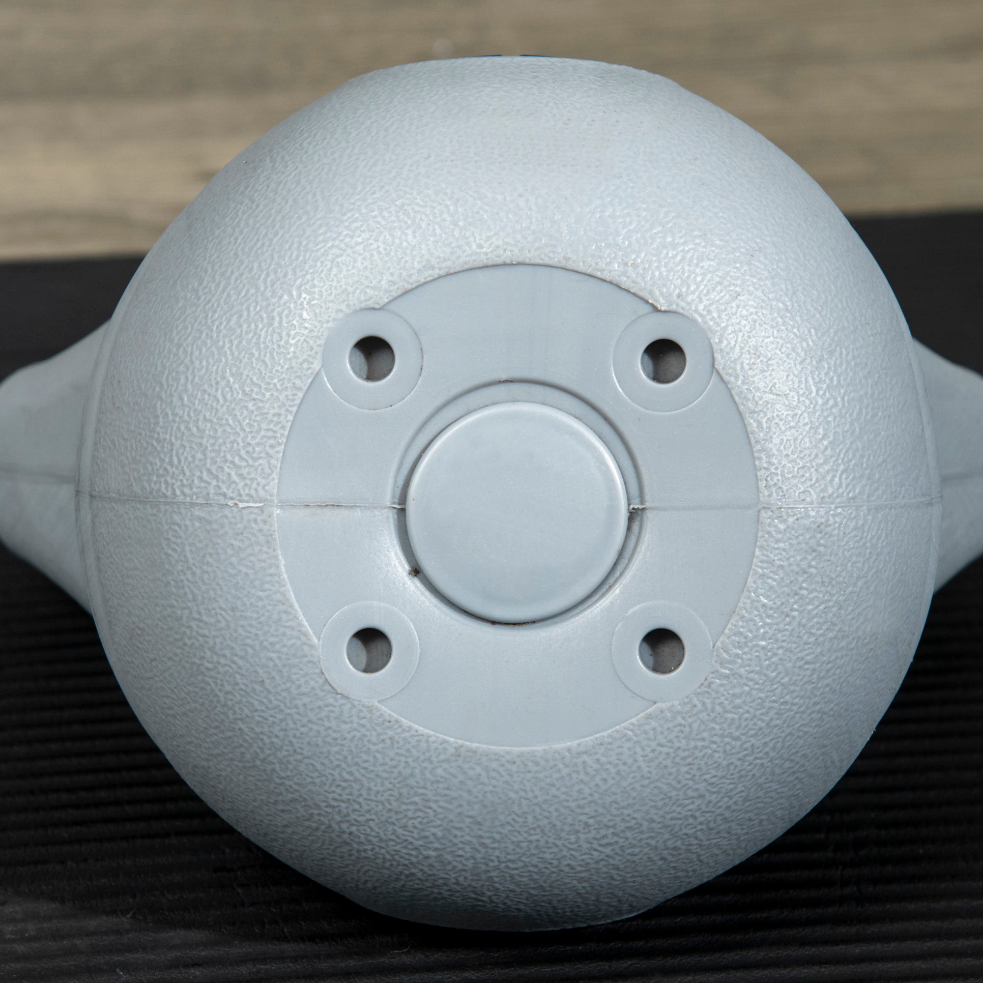 Gray textured teapot base with four holes and button featured with sportnow kettlebell for strength training