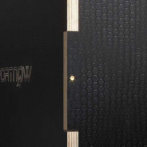 Black textured wooden jump box with vertical gold metallic strip and embossed lettering for home gym use