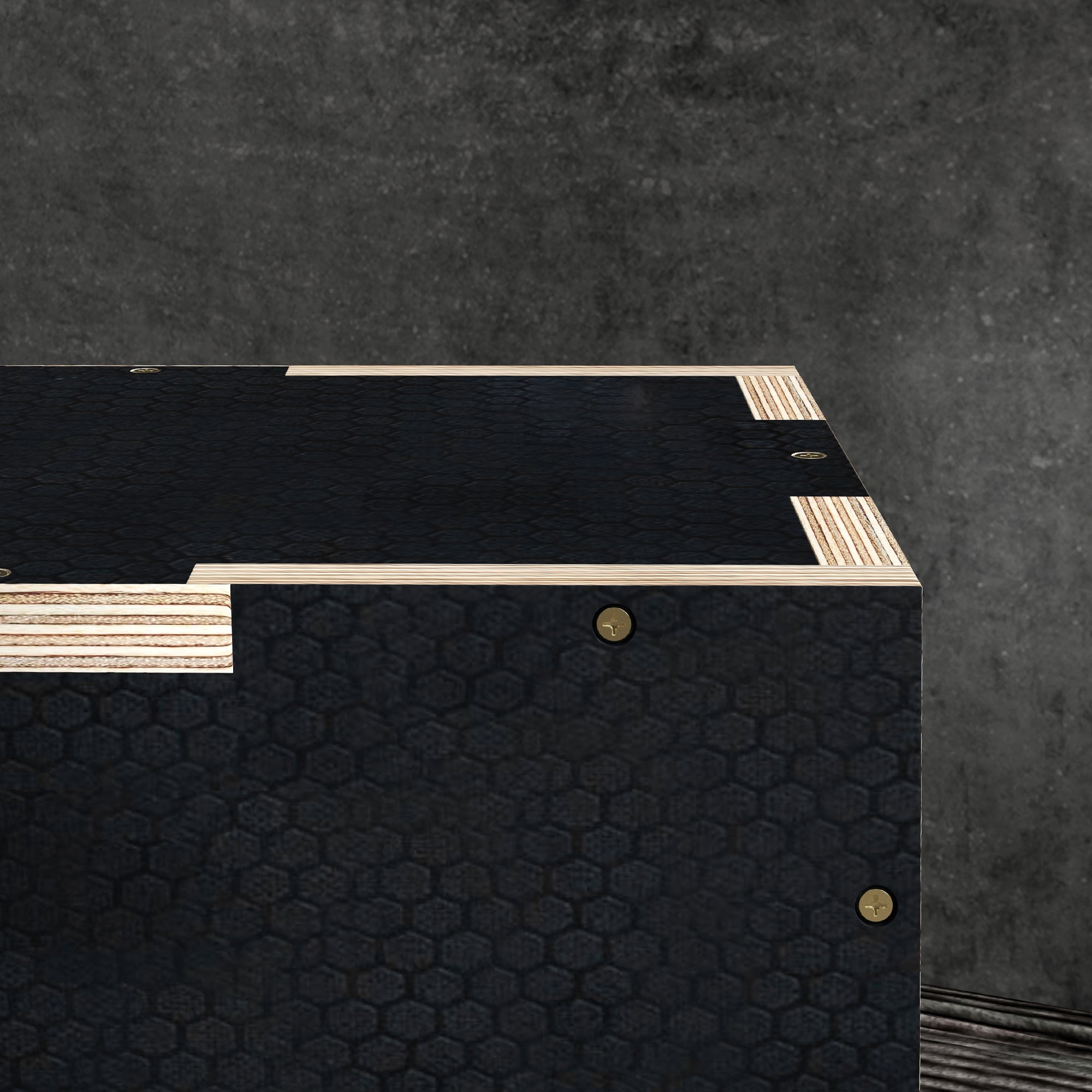 Black wooden jump box with hexagonal pattern, light wood trim, and brass fasteners for home and gym use