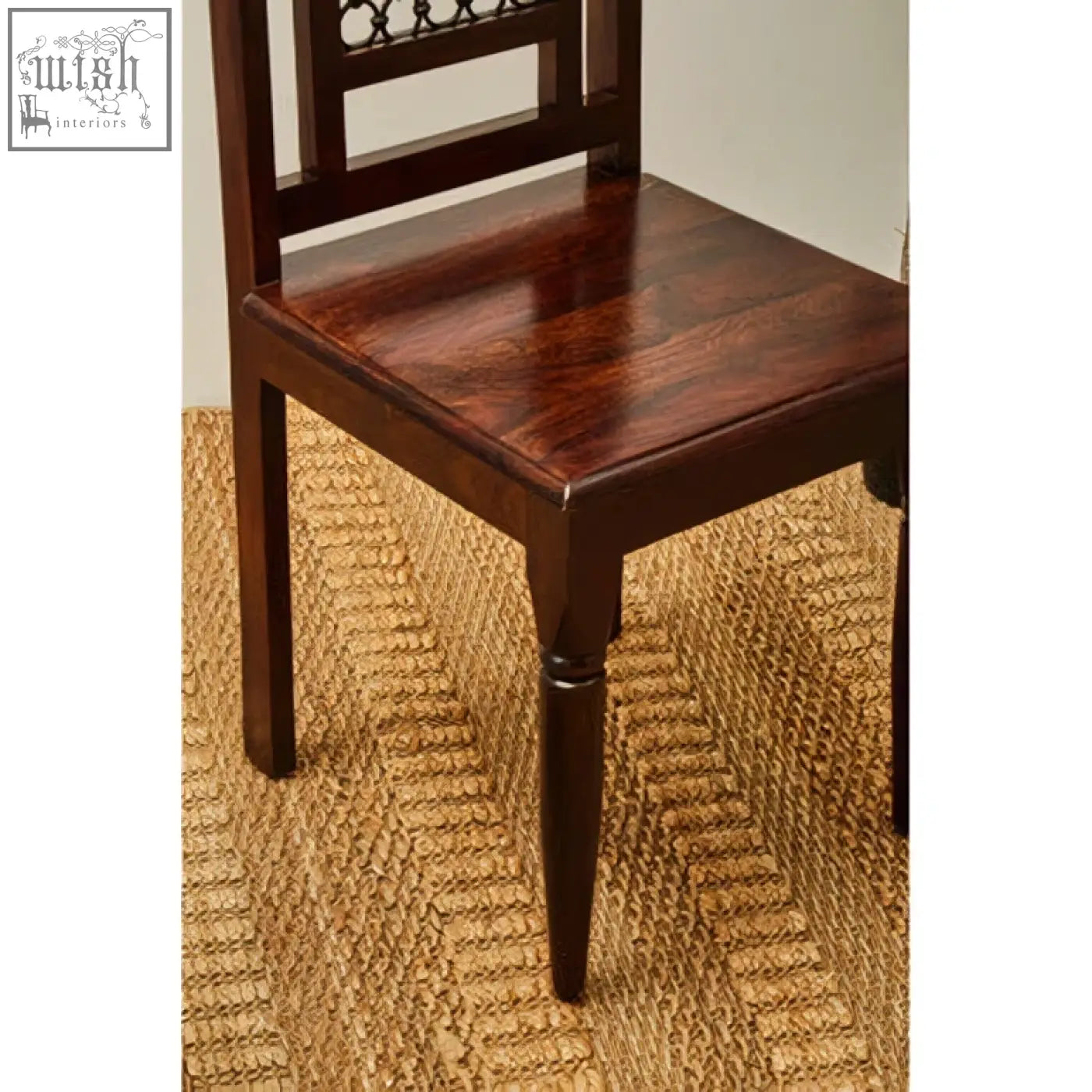 Dark brown sheesham wood dining chair with polished finish and ornate backrest for wood dining spaces
