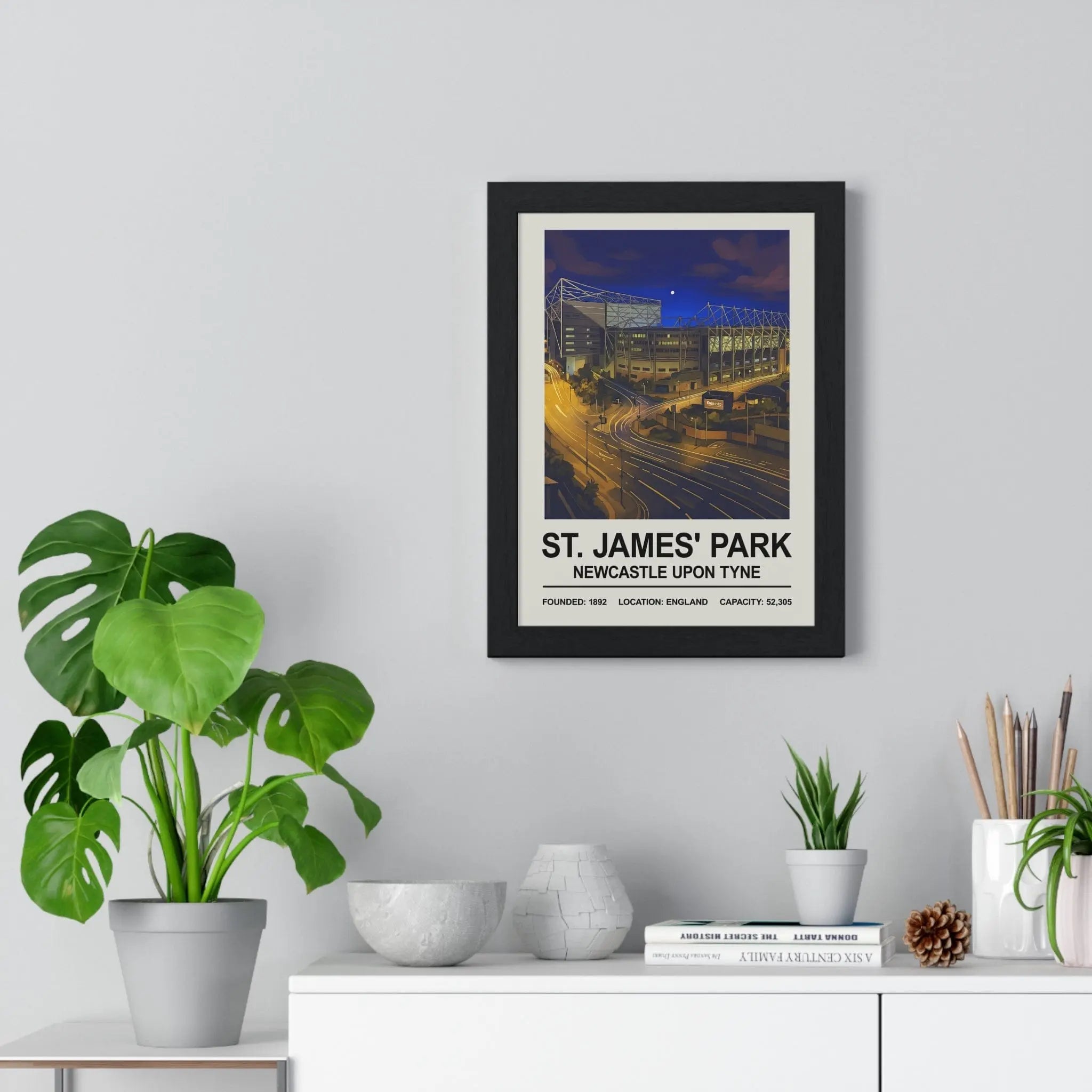 Black-framed night edition stadium print of st james park newcastle showcasing vibrant night colors