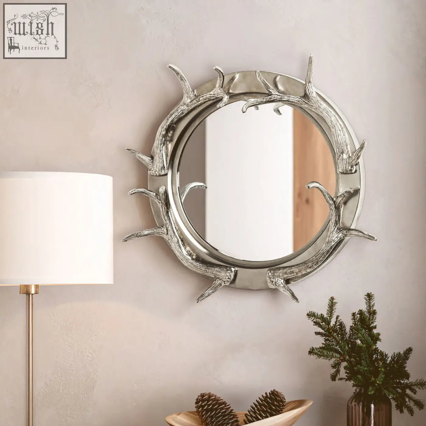 Silver stag antler steel wall mirror with a round nickel finish frame and polished metallic look