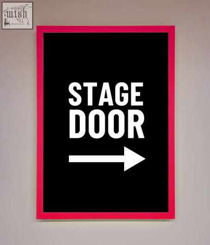 A bold pink stage door framed print with a black background white text and a right pointing arrow sign