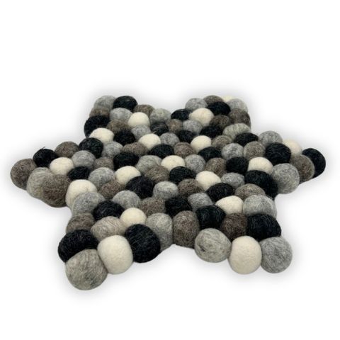 Star shape centre mat made of fluffy wool balls in black white and grey perfect for cozy home decor