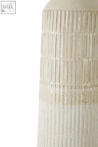 Cream-colored ceramic steen large vase with vertical ribbed texture and subtle speckled finish in glazed stoneware