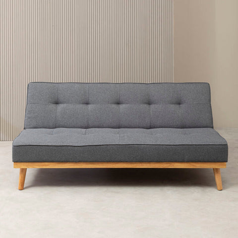 Grey sofa bed with tufted fabric and light wood legs perfect for a modern living room or guest space