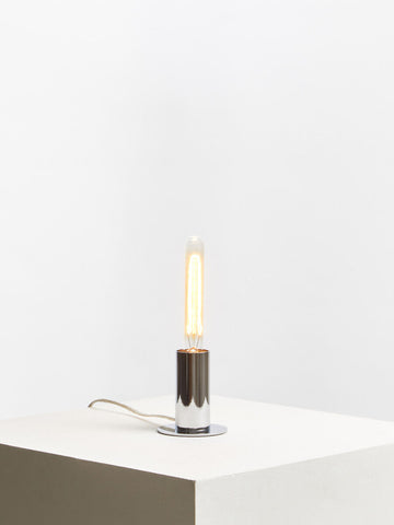 Minimalist stockholm chrome finish table lamp with chrome finish base and glowing edison-style filament bulb