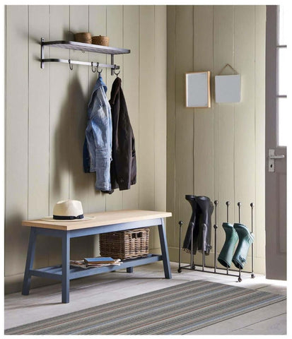 Blue wooden bench with straw hat and basket below on stockholm grey clay washable mat for easy cleaning and style