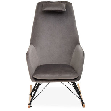 A sleek stockholm grey velvet rocking chair with soft upholstery, cushioned headrest, and slender black metal legs
