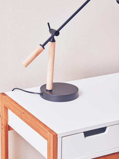 Modern stockholm matte black table lamp with matte black metal arm and wooden handle on a round matte black base