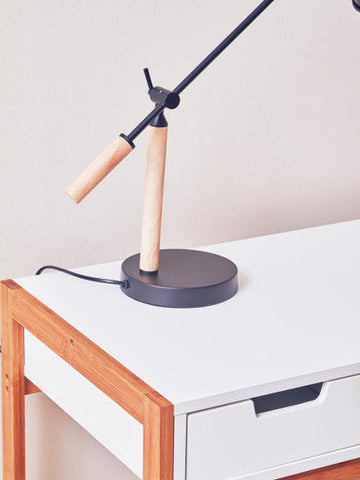 Modern stockholm matte black table lamp with matte black metal arm and wooden handle on a round matte black base