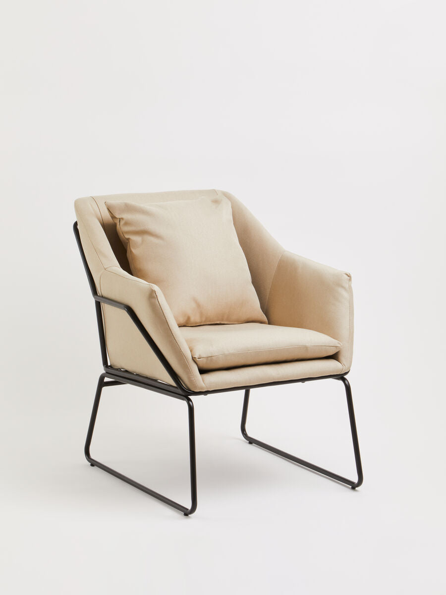 Beige upholstered stockholm stone armchair with sleek black metal frame perfect for stylish living spaces