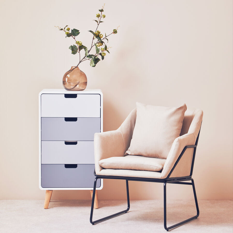Beige upholstered stockholm stone armchair with black metal frame and matching cushion for cozy seating