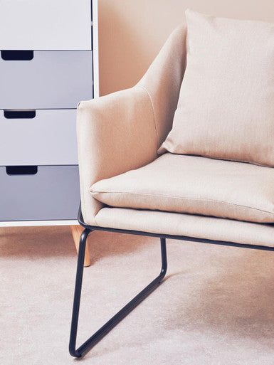 Beige upholstered stockholm stone armchair with black metal frame perfect for cozy seating at home