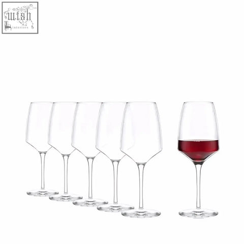 A clear elegant stolzle experience red wine glass with a slender stem filled with deep red wine perfect for tasting