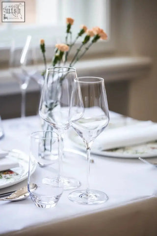 Clear crystal stolzle lausitz quatrophil red wine glasses with slender stems and tapered bowls on white cloth