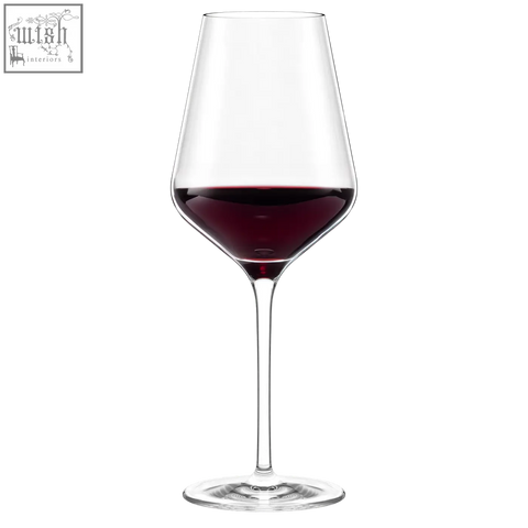 A clear stolzle lausitz quarto phil red wine glass with a slender stem and wide bowl filled with deep red wine