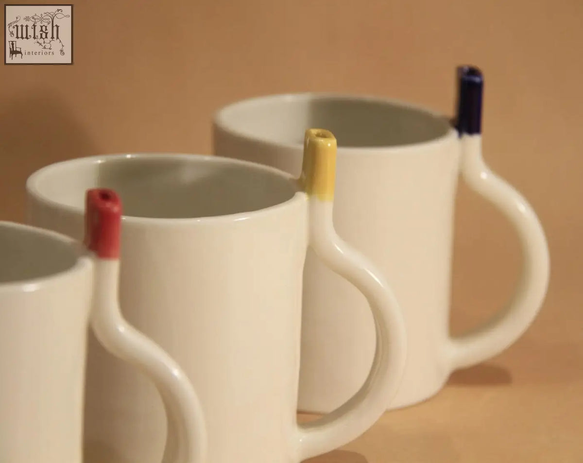 White ceramic straw cup mugs with colorful tapered handles in red yellow and blue perfect for everyday use