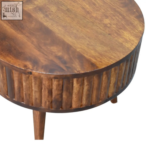 Rounded stripe chestnut coffee table in warm brown mango wood with vertical fluted detailing on the base