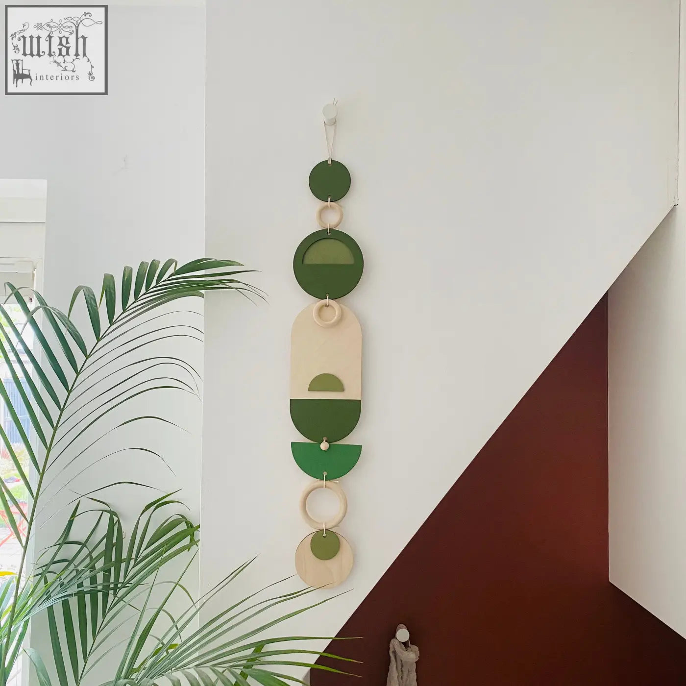 A stylish green geometric wall art made of layered wooden circles for modern minimalistic home decor