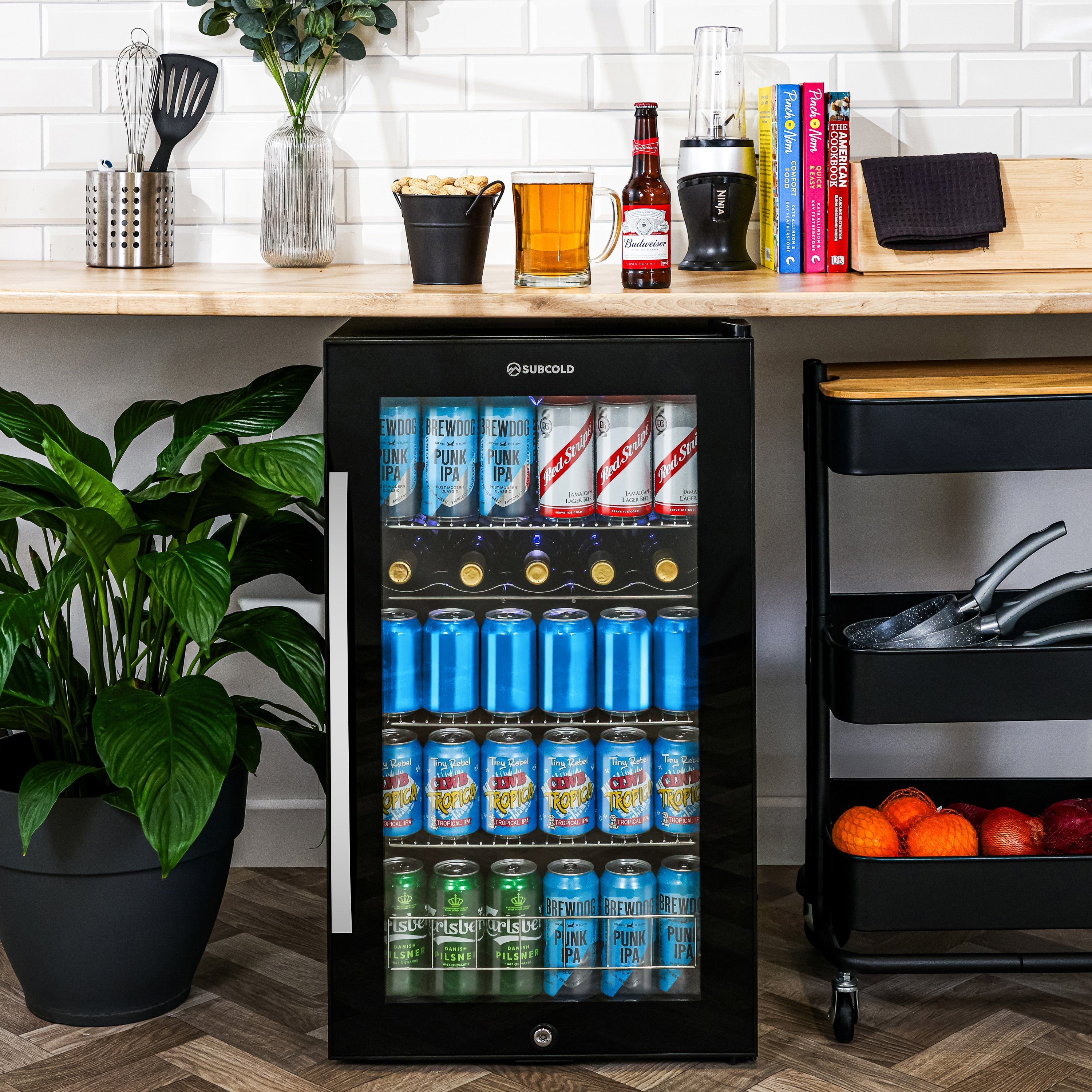 Black glass-door subcold ace100 beer fridge with silver handle and gold bottle holders for cool storage