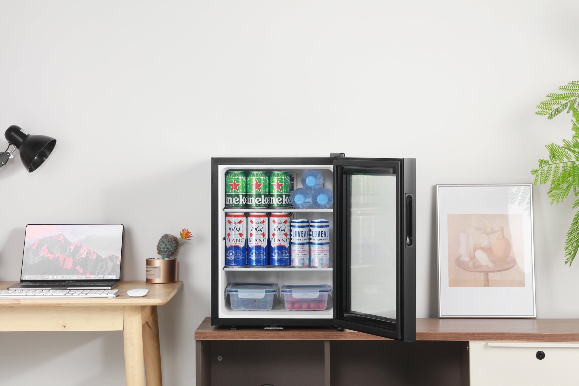Black-framed subcold aire40-g mini fridge with glass door and shelves stocked with beverages for easy access