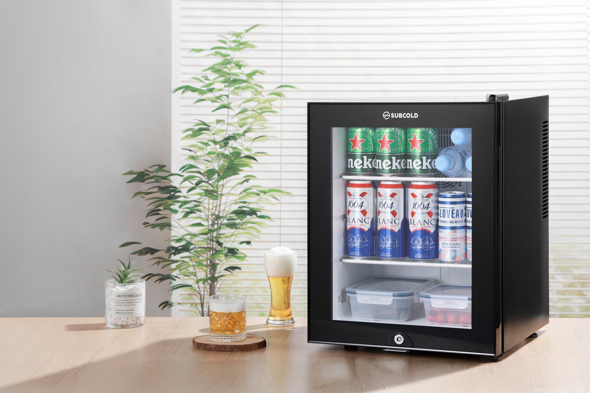 Black glass door subcold aire40-g mini fridge with silver handle and brand logo on top perfect for compact spaces