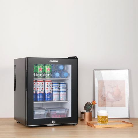 Black glass-door subcold aire40-g mini fridge with sleek modern design and stocked interior shelves of beverages