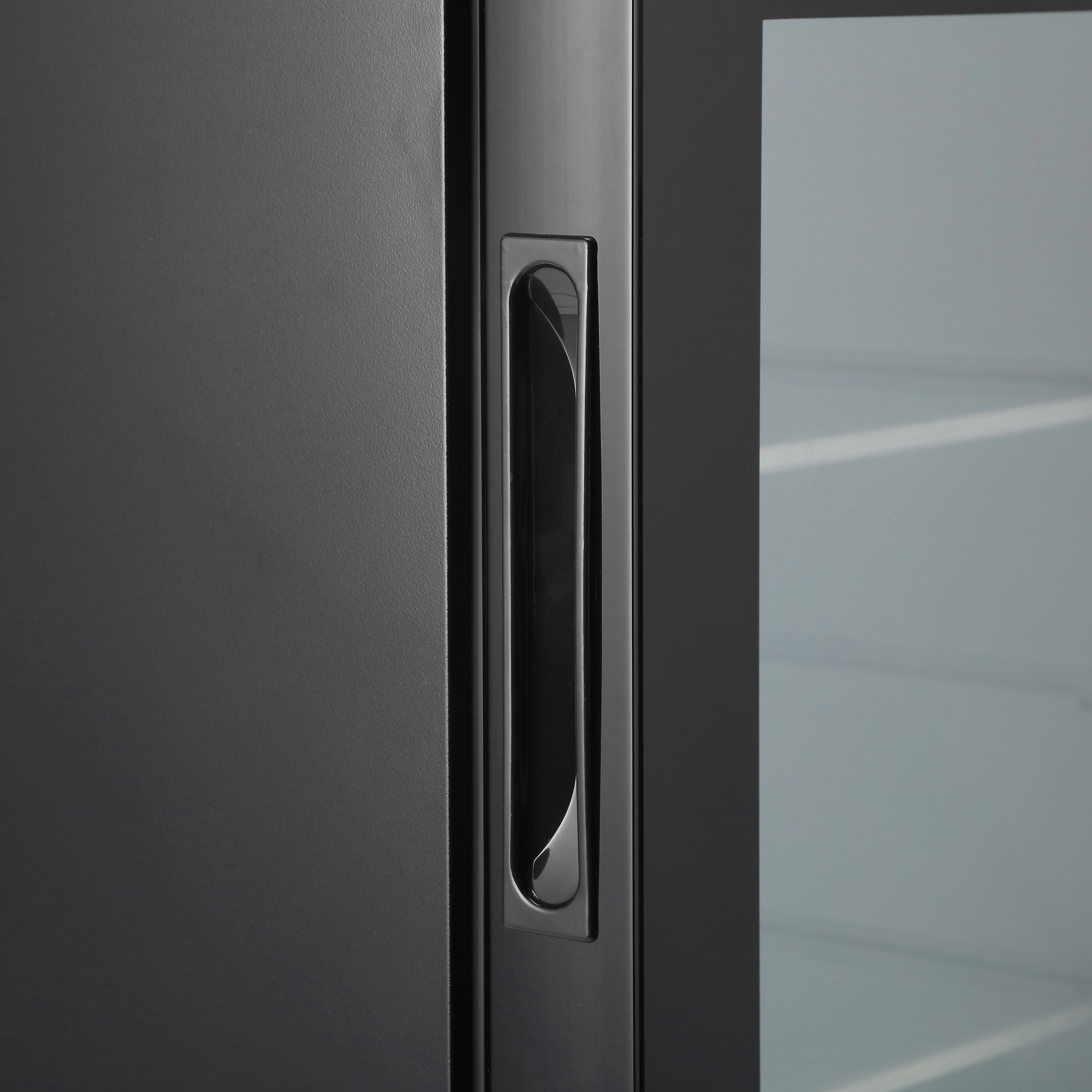 A sleek black door handle with polished chrome finish on the subcold aire40-g mini fridge for a modern look