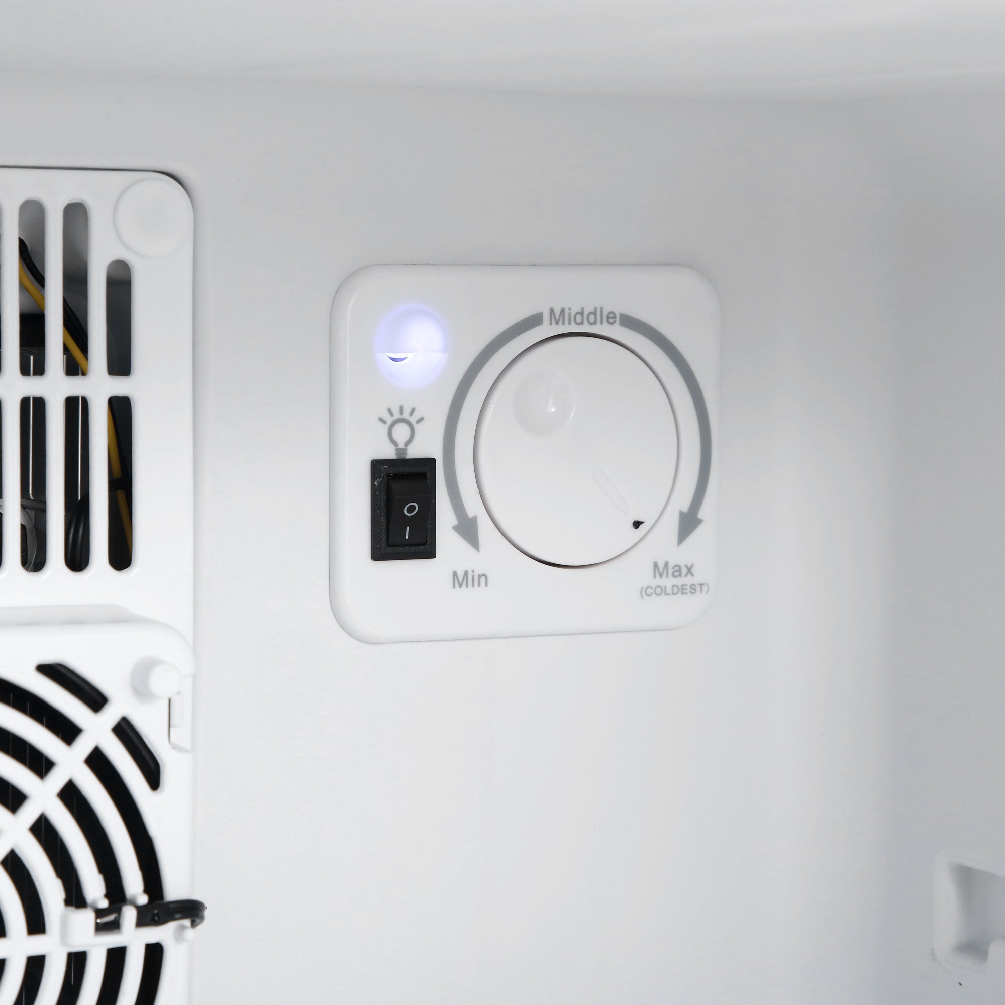 White plastic control panel with temperature dial and power switch on subcold aire40-g mini fridge