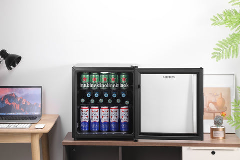 Black-framed Subcold Cave50 glass door beer fridge with silver interior stocked with Heineken and Budweiser cans
