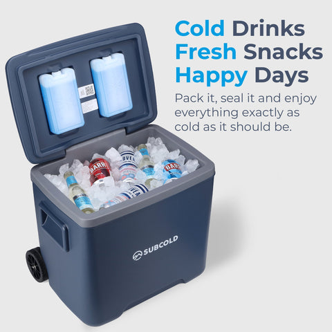 Dark blue subcold chilly30 cool box with gray trim and black wheels filled with ice and cold drinks portable cool box