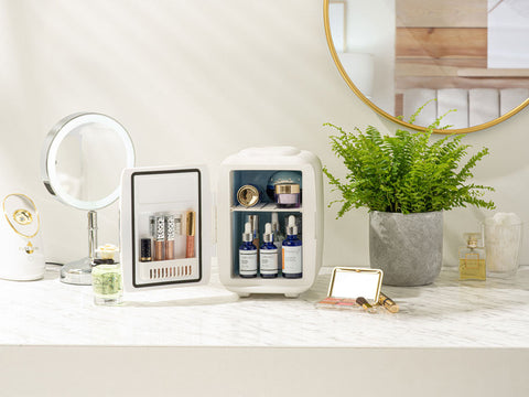 White subcold classic 4l mini fridge with mirrored door and two shelves holding skincare products for easy storage