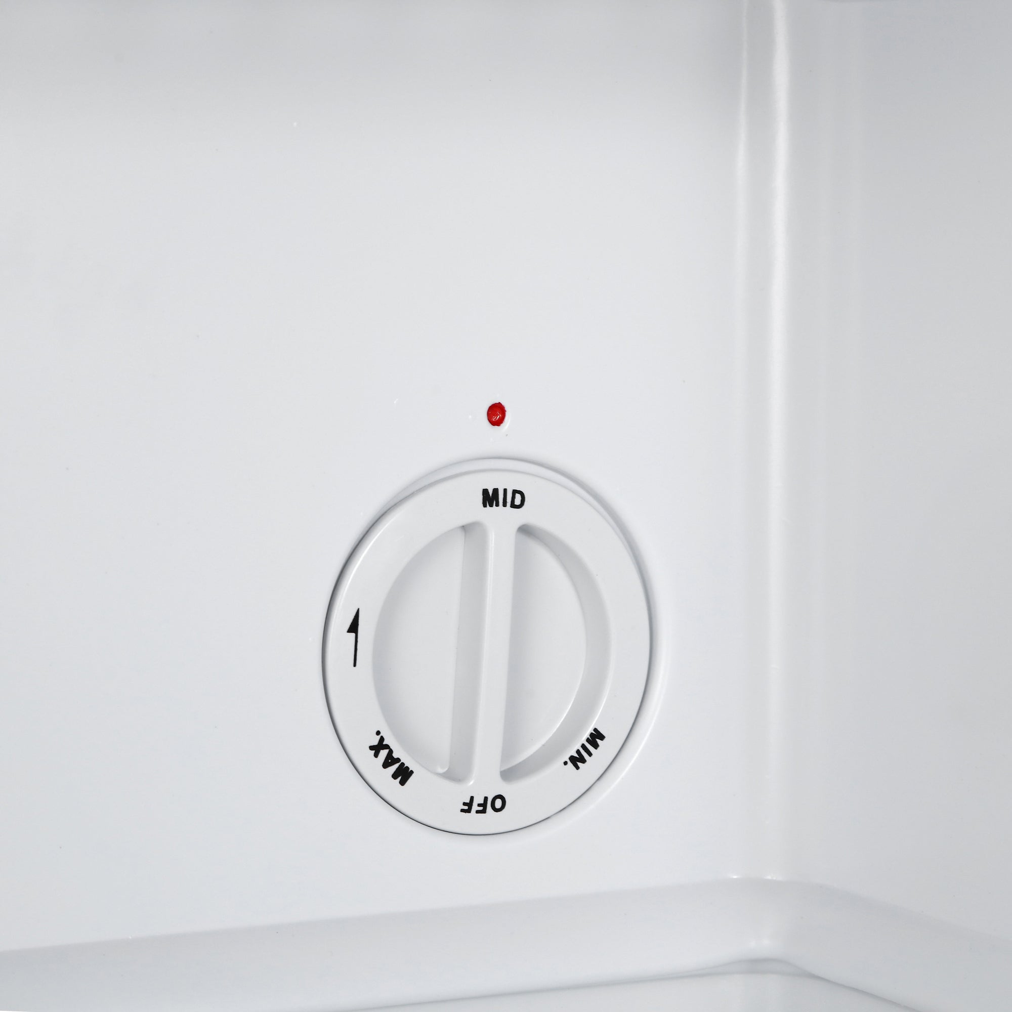 White circular temperature control dial with off mid min and max settings on black subcold eco35f mini freezer