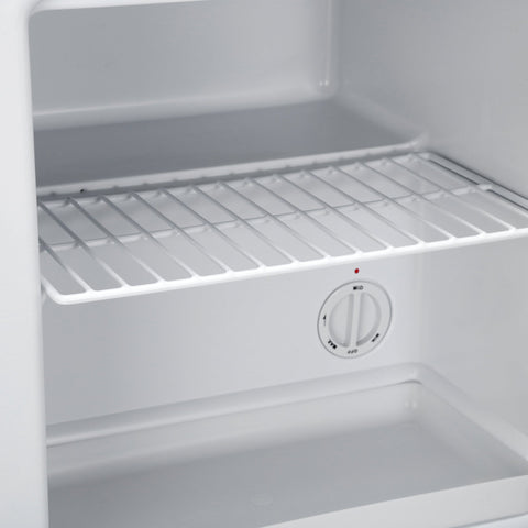 White plastic wire shelf with temperature control dial inside black subcold eco35f mini freezer interior wall