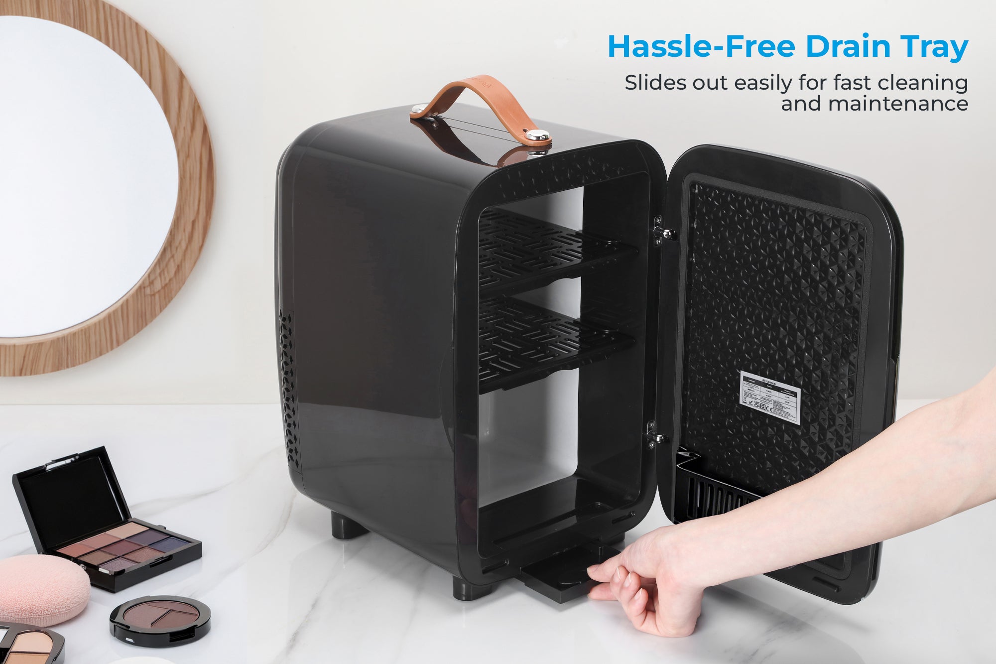 Black glossy subcold pro 10l mini fridge with tan leather handle and textured interior shelves for makeup storage