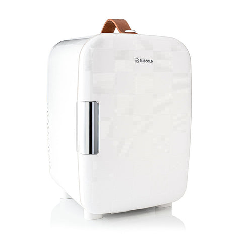 White subcold pro 10l mini fridge with textured surface silver handle and brown leather carry strap compact 10l mini fridge