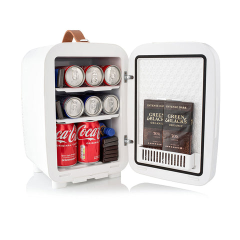 White subcold pro 10l mini fridge with brown leather handle and shelves stocked with soda cans and chocolate bars